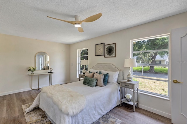 822 Glen Arden Way, Altamonte Springs, FL 32701 - bedroom with wood finished floors, a textured ceiling, ceiling fan, and baseboards