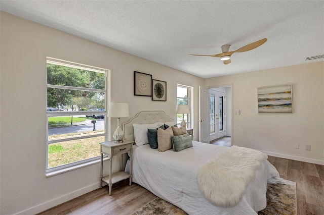 822 Glen Arden Way, Altamonte Springs, FL 32701 - bedroom featuring wood finished floors, a textured ceiling, baseboards, and ceiling fan