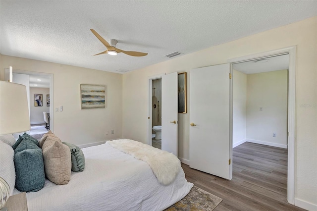 822 Glen Arden Way, Altamonte Springs, FL 32701 - bedroom featuring wood finished floors, connected bathroom, baseboards, a textured ceiling, and ceiling fan