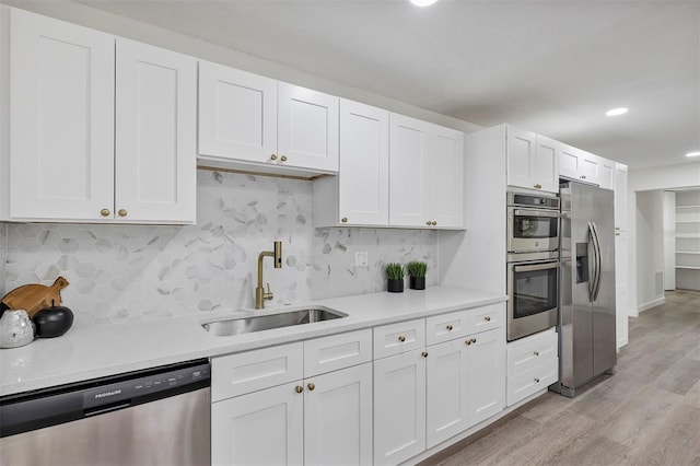 822 Glen Arden Way, Altamonte Springs, FL 32701 - kitchen with appliances with stainless steel finishes, light countertops, white cabinets, backsplash, and recessed lighting