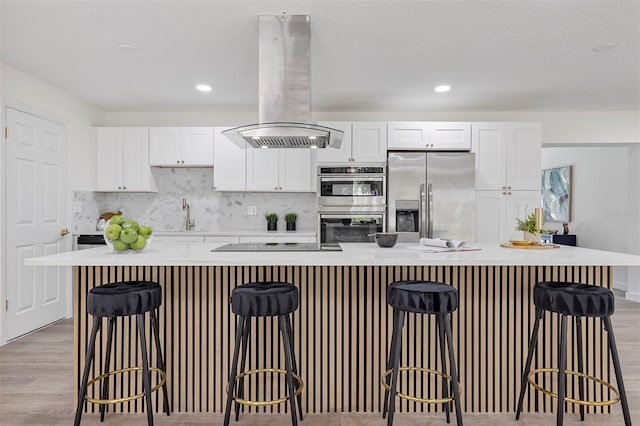 822 Glen Arden Way, Altamonte Springs, FL 32701 - kitchen featuring appliances with stainless steel finishes, ventilation hood, white cabinetry, light wood-style floors, and light countertops