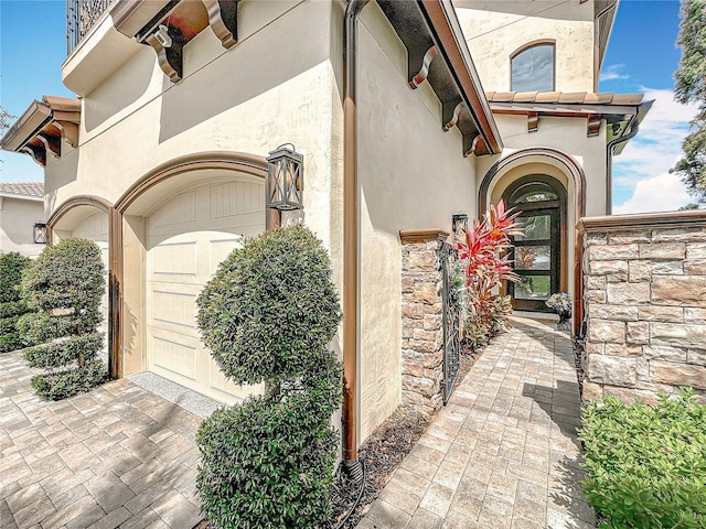 16246 Ravenna Ct, Montverde, FL 34756 - doorway to property with stucco siding and stone siding