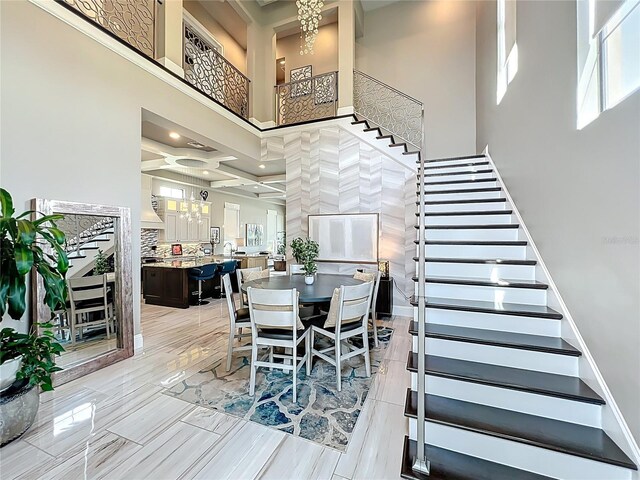 16246 Ravenna Ct, Montverde, FL 34756 - dining area featuring stairway, a towering ceiling, and a chandelier