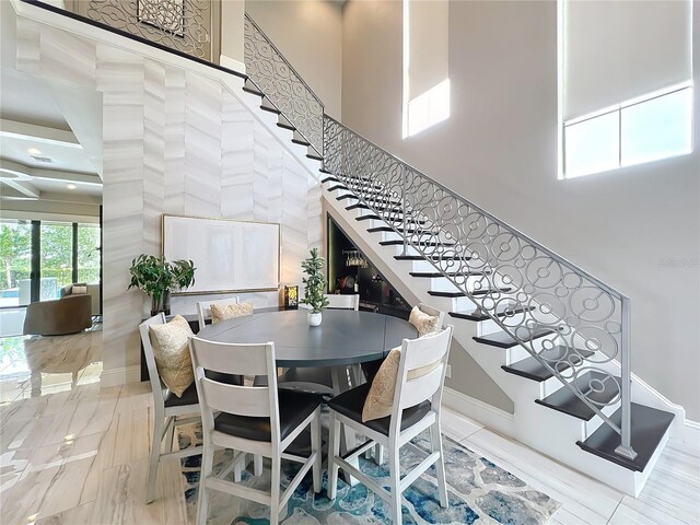 16246 Ravenna Ct, Montverde, FL 34756 - dining room with stairs, a high ceiling, and baseboards