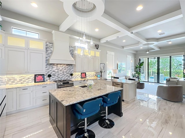 16246 Ravenna Ct, Montverde, FL 34756 - kitchen featuring coffered ceiling, backsplash, open floor plan, wall chimney range hood, and a center island with sink