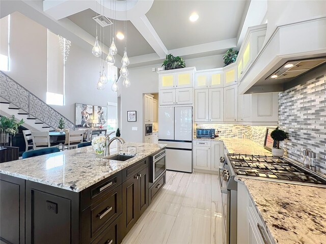 16246 Ravenna Ct, Montverde, FL 34756 - kitchen featuring white fridge, stove, a sink, white cabinetry, and coffered ceiling