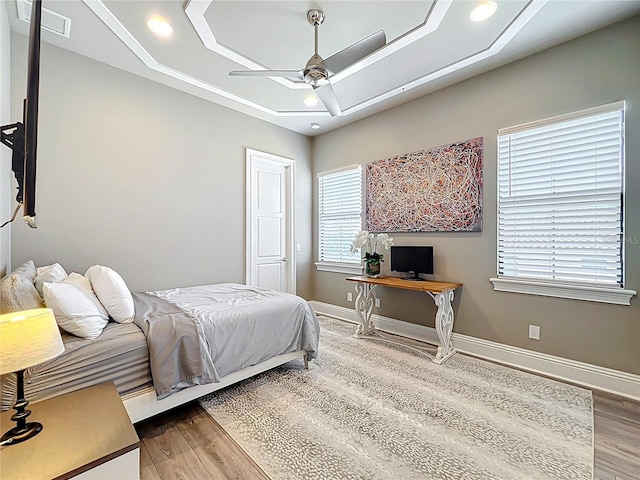 16246 Ravenna Ct, Montverde, FL 34756 - bedroom featuring wood finished floors, a tray ceiling, baseboards, a ceiling fan, and recessed lighting