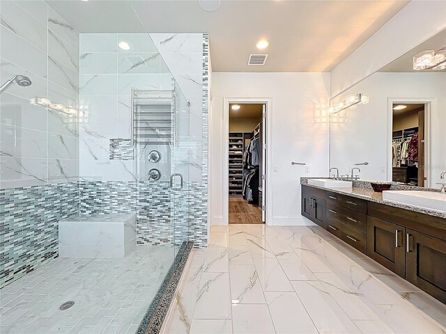 16246 Ravenna Ct, Montverde, FL 34756 - bathroom featuring a spacious closet, double vanity, a stall shower, marble finish flooring, and recessed lighting
