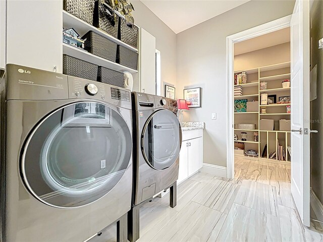 16246 Ravenna Ct, Montverde, FL 34756 - washroom featuring cabinet space, washing machine and dryer, and baseboards