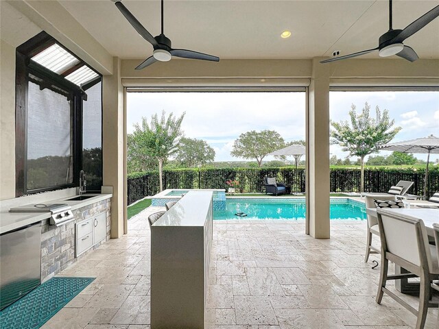 16246 Ravenna Ct, Montverde, FL 34756 - view of swimming pool with a ceiling fan, exterior kitchen, a sink, and a fenced backyard