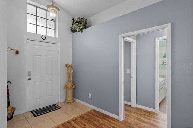 404 Obo Dr, Davenport, FL 33896 - entryway with light tile patterned floors and baseboards
