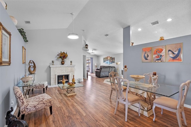 404 Obo Dr, Davenport, FL 33896 - dining area featuring wood finished floors, baseboards, a glass covered fireplace, and recessed lighting