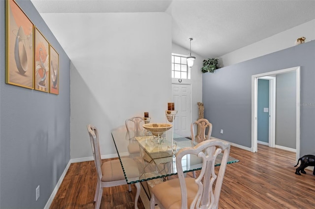 404 Obo Dr, Davenport, FL 33896 - dining room featuring wood finished floors, vaulted ceiling, and baseboards