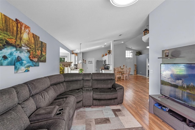404 Obo Dr, Davenport, FL 33896 - living room featuring lofted ceiling and light wood finished floors