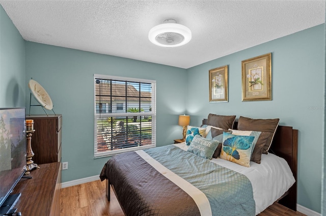 404 Obo Dr, Davenport, FL 33896 - bedroom featuring wood finished floors, a textured ceiling, and baseboards