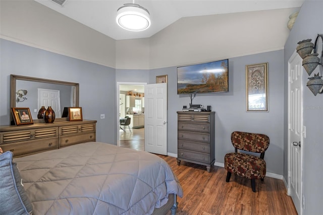 404 Obo Dr, Davenport, FL 33896 - bedroom featuring lofted ceiling, wood finished floors, and baseboards