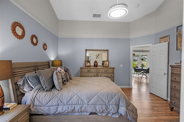 404 Obo Dr, Davenport, FL 33896 - bedroom featuring wood finished floors, high vaulted ceiling, and baseboards
