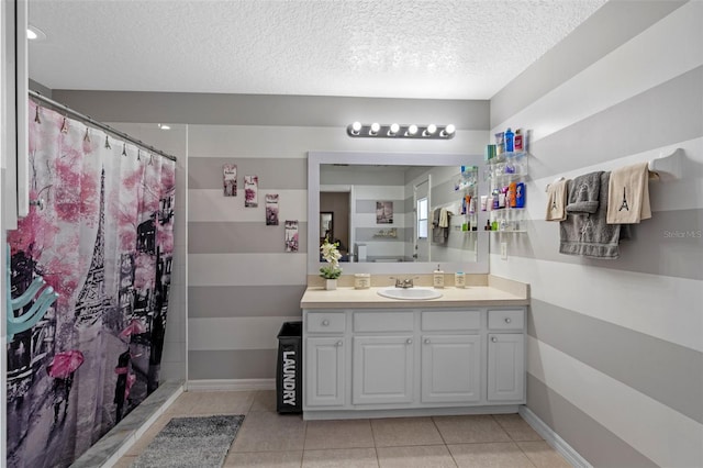 404 Obo Dr, Davenport, FL 33896 - bathroom featuring a textured ceiling, vanity, tile patterned flooring, and baseboards