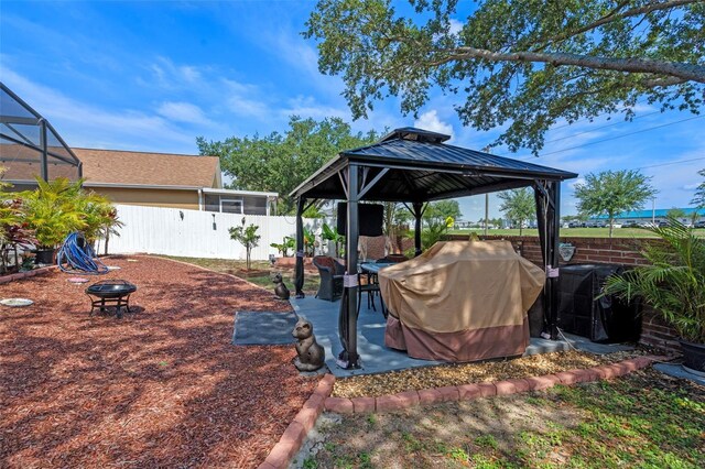 404 Obo Dr, Davenport, FL 33896 - fenced backyard with a gazebo, an outdoor fire pit, and a patio area