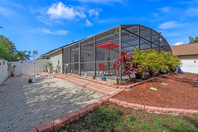 404 Obo Dr, Davenport, FL 33896 - back of property featuring a patio area, a gate, a fenced backyard, and a lanai