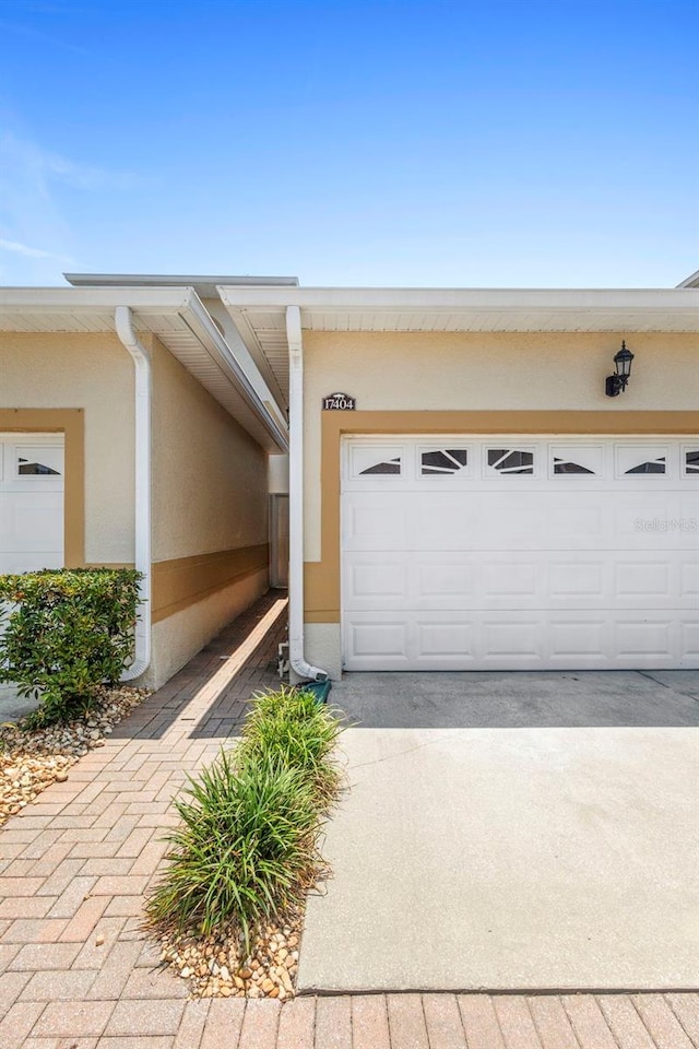 17404 Chateau Pine Way, Clermont, FL 34711 - garage featuring driveway