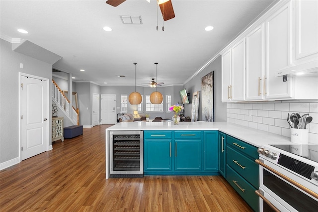 17404 Chateau Pine Way, Clermont, FL 34711 - kitchen featuring ceiling fan, wine cooler, a peninsula, electric range oven, and recessed lighting