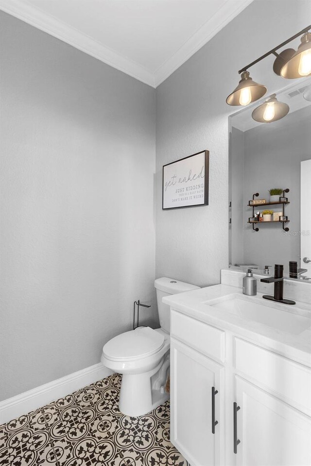 17404 Chateau Pine Way, Clermont, FL 34711 - half bath with vanity, toilet, ornamental molding, and baseboards