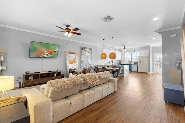 17404 Chateau Pine Way, Clermont, FL 34711 - living area featuring ceiling fan, ornamental molding, wood finished floors, recessed lighting, and baseboards