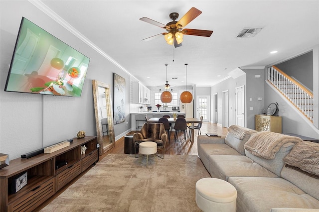 17404 Chateau Pine Way, Clermont, FL 34711 - living room with ceiling fan, crown molding, light wood-style flooring, stairway, and recessed lighting