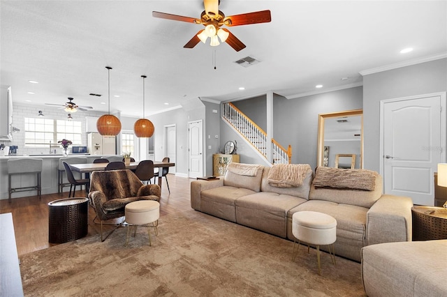 17404 Chateau Pine Way, Clermont, FL 34711 - living room with a ceiling fan, recessed lighting, stairs, crown molding, and wood finished floors