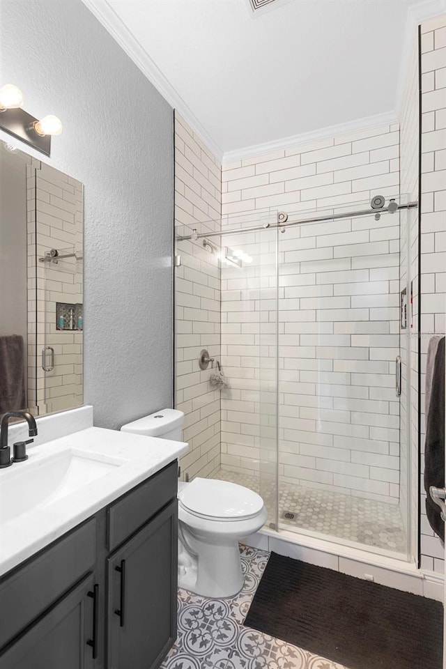 17404 Chateau Pine Way, Clermont, FL 34711 - bathroom featuring a stall shower, vanity, toilet, a textured wall, and tile patterned floors
