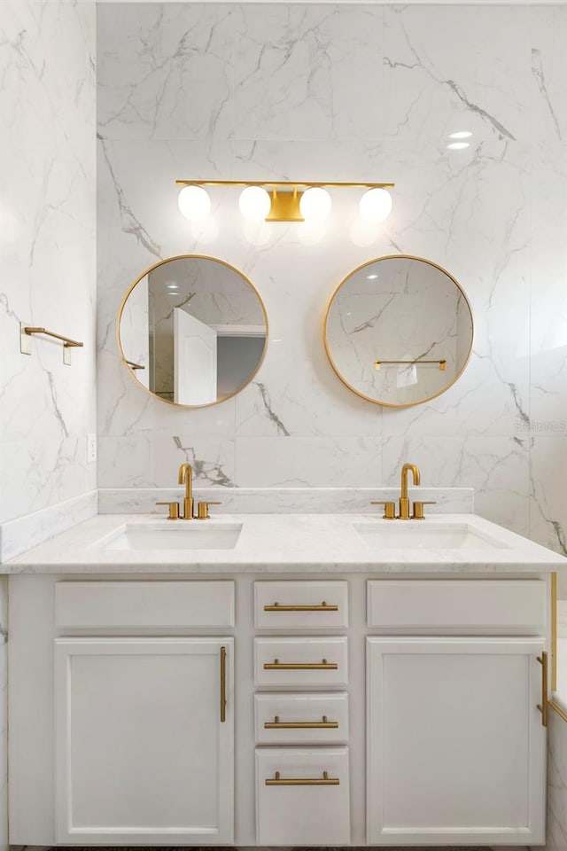 17404 Chateau Pine Way, Clermont, FL 34711 - bathroom featuring double vanity, tile walls, and decorative backsplash