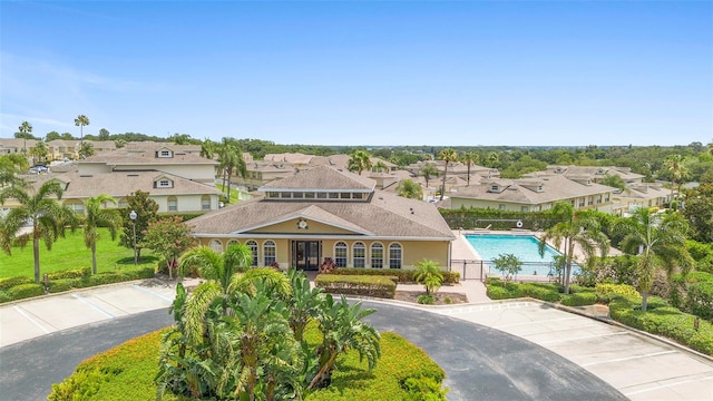 17404 Chateau Pine Way, Clermont, FL 34711 - mediterranean / spanish-style house featuring a residential view and a community pool