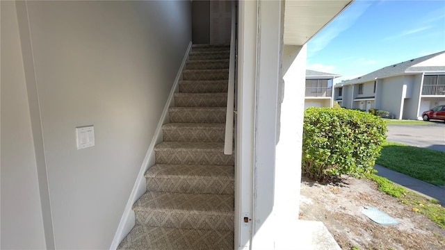 stairway featuring baseboards