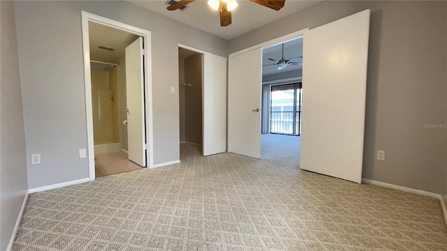 unfurnished bedroom with light carpet, baseboards, ensuite bath, and ceiling fan