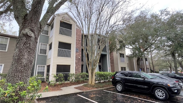 view of property with uncovered parking