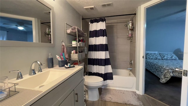 ensuite bathroom with wood finished floors, vanity, shower / tub combo with curtain, ceiling fan, and toilet