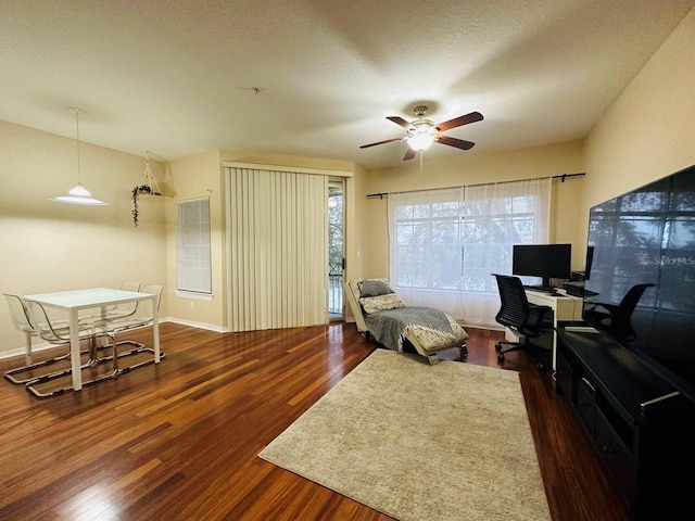 office area with plenty of natural light, wood finished floors, and ceiling fan