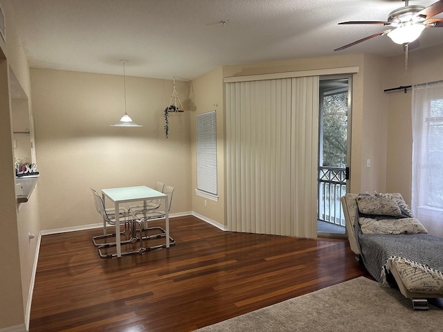dining area with wood finished floors, ceiling fan, and baseboards