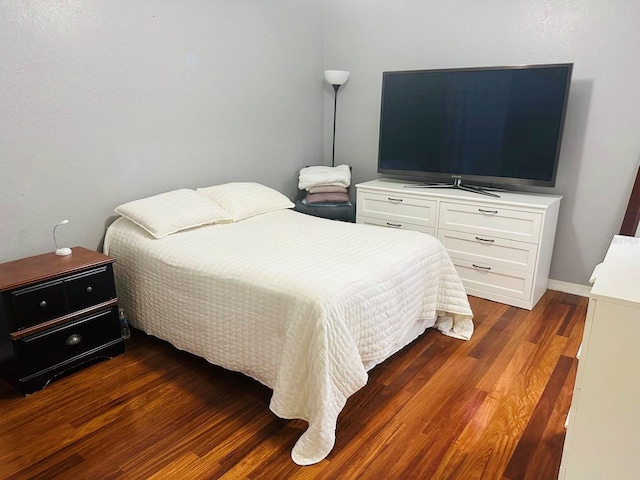 bedroom featuring dark wood-style flooring