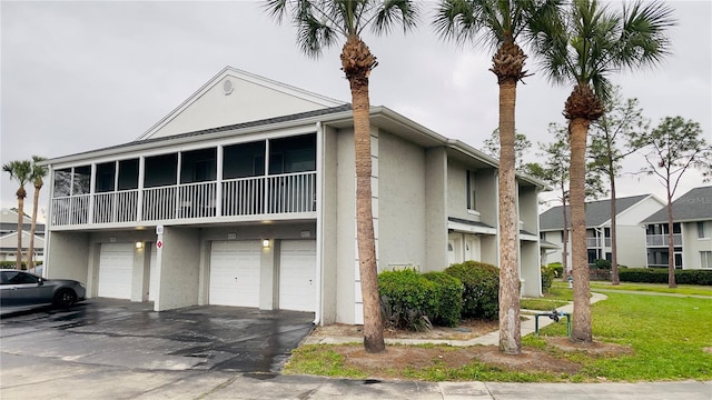 view of property featuring a garage and driveway