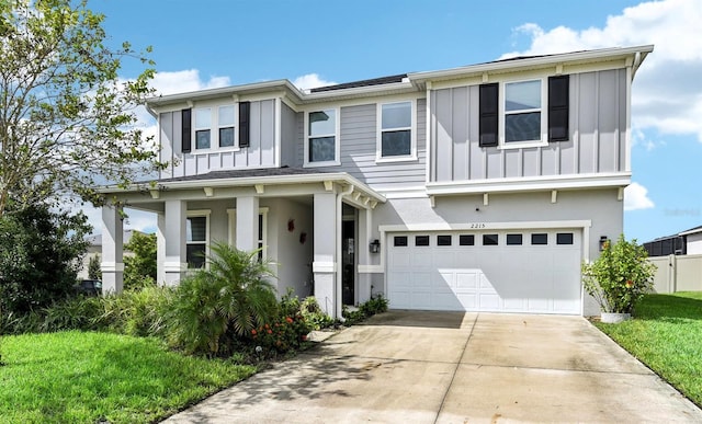 2215 Upland Ln, Apopka, FL 32712 - view of front of home with board and batten siding, a garage, driveway, stucco siding, and a porch