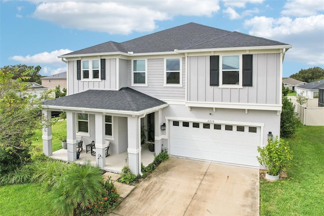2215 Upland Ln, Apopka, FL 32712 - view of front of home featuring covered porch, board and batten siding, a shingled roof, and an attached garage
