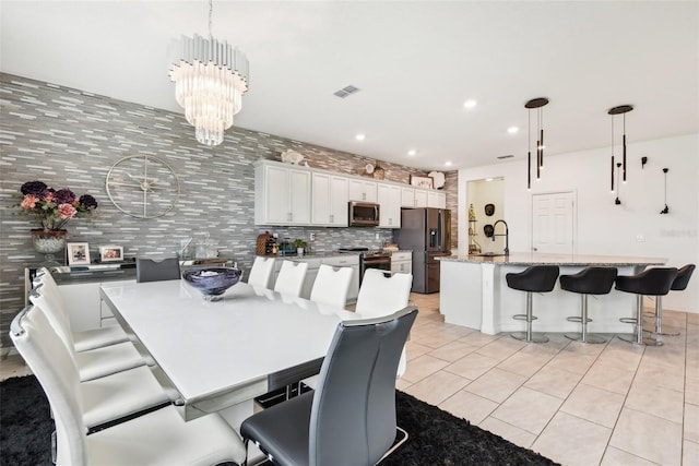 2215 Upland Ln, Apopka, FL 32712 - dining space with light tile patterned floors, recessed lighting, and a chandelier