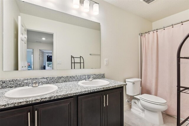 2215 Upland Ln, Apopka, FL 32712 - bathroom with double vanity and tile patterned flooring
