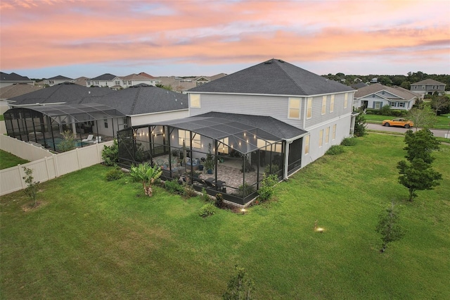2215 Upland Ln, Apopka, FL 32712 - back of property with a residential view, a fenced backyard, roof with shingles, glass enclosure, and a patio area