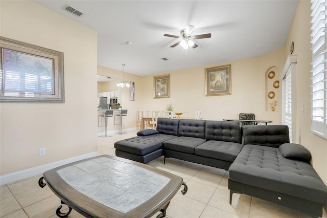 3938 Calabria Ave, Davenport, FL 33897 - living area featuring light tile patterned floors, ceiling fan, a chandelier, and baseboards