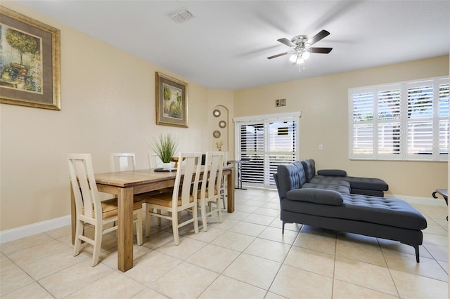 3938 Calabria Ave, Davenport, FL 33897 - dining area with ceiling fan, light tile patterned floors, and baseboards