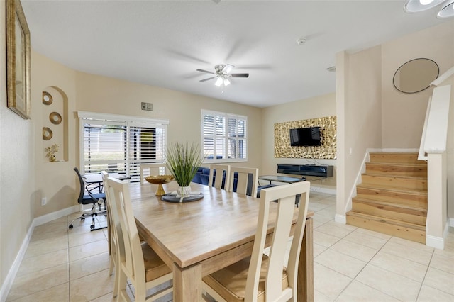 3938 Calabria Ave, Davenport, FL 33897 - dining area featuring ceiling fan, light tile patterned floors, baseboards, and stairs