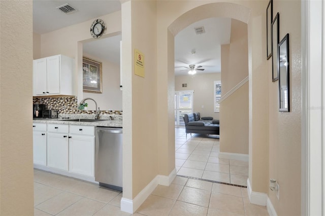 3938 Calabria Ave, Davenport, FL 33897 - bar area featuring dishwasher, a sink, a ceiling fan, light tile patterned floors, and arched walkways
